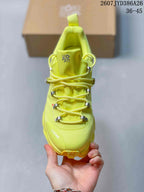 Top view of the neon yellow sneaker showing the layered cord lacing system, tongue branding, and textured upper.