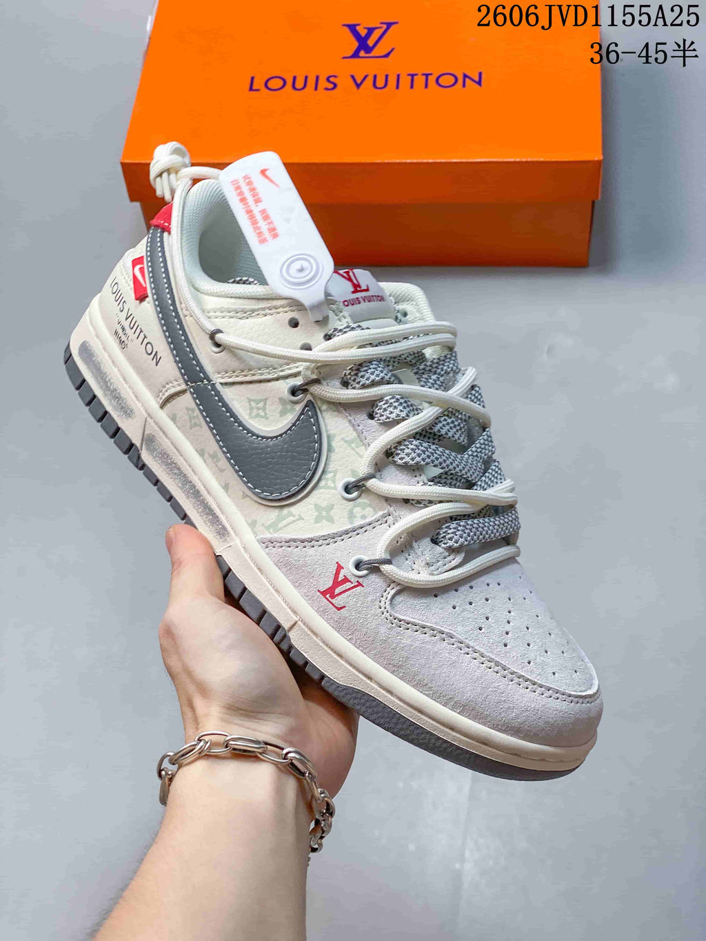 Side view of a cream and gray patterned low-top sneaker with contrasting overlays