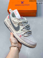 Side view of a cream and gray patterned low-top sneaker with contrasting overlays