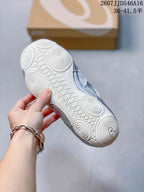 Underside view of a silver and white ASICS sneaker showing a white rubber outsole with circular traction details; overlay text shows sizes 36–41.5.