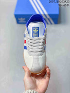 Top view showing the white laces, tongue label, blue collar, and rounded toe.