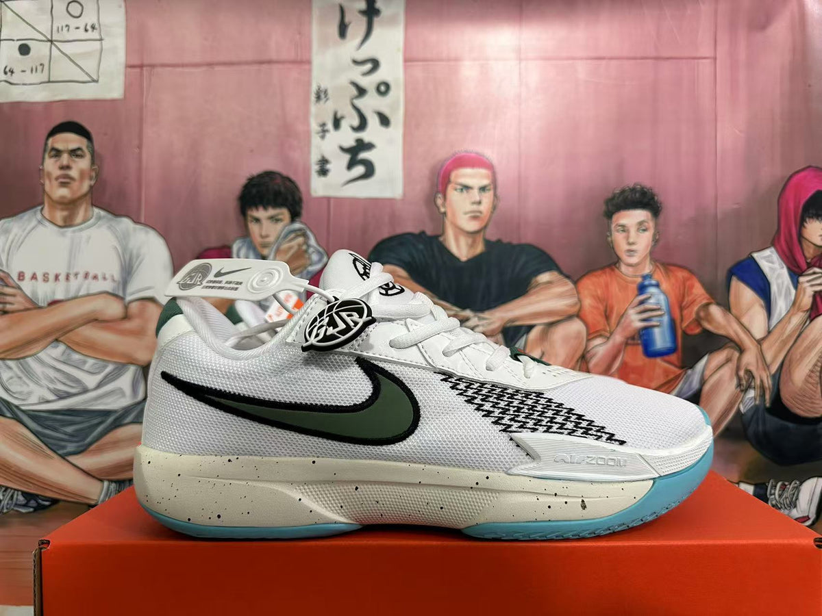 Side profile of a white Nike basketball sneaker with a dark green and black swoosh, patterned side detail, speckled midsole, and blue-green outsole.