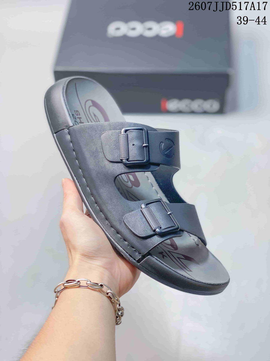 Angled view of the dark gray ECCO sandal showing both adjustable buckle straps, open toe, and stitched sole edge.