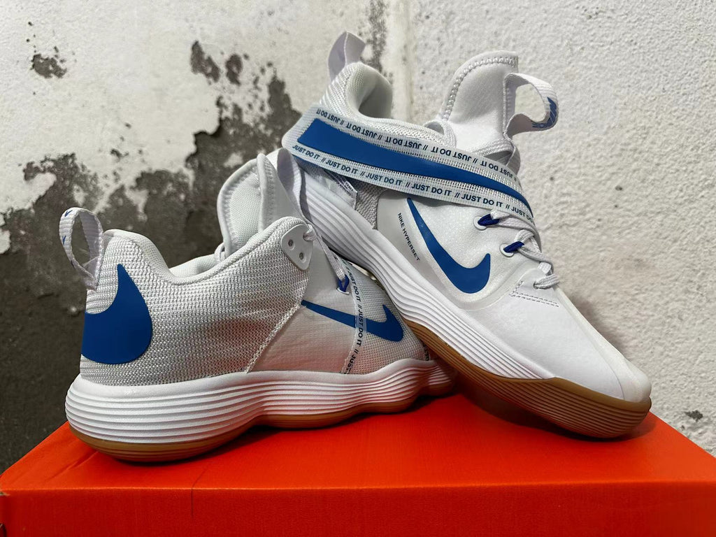 Pair of white and blue Nike Hyperdunk basketball shoes showing the side profile and adjustable strap.
