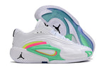 Side and outsole views of white Jordan Luka 3 shoes with green and pink accents