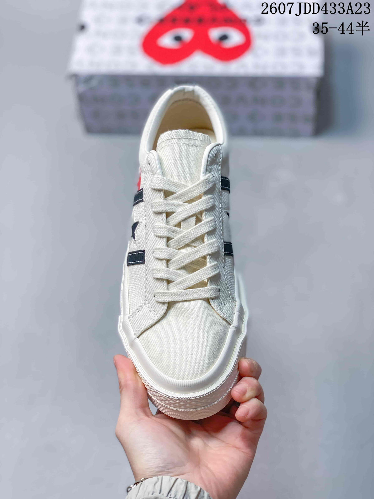 Top view showing the off-white toe box, white laces and dark side stripes.