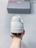 Rear view of the white low-top sneaker showing the heel counter, stitching and layered white sole.