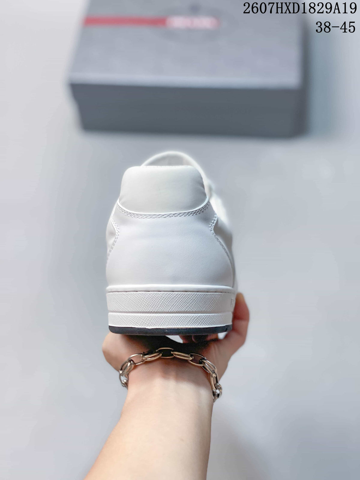 Rear view of the white low-top sneaker showing the heel counter, stitching and layered white sole.