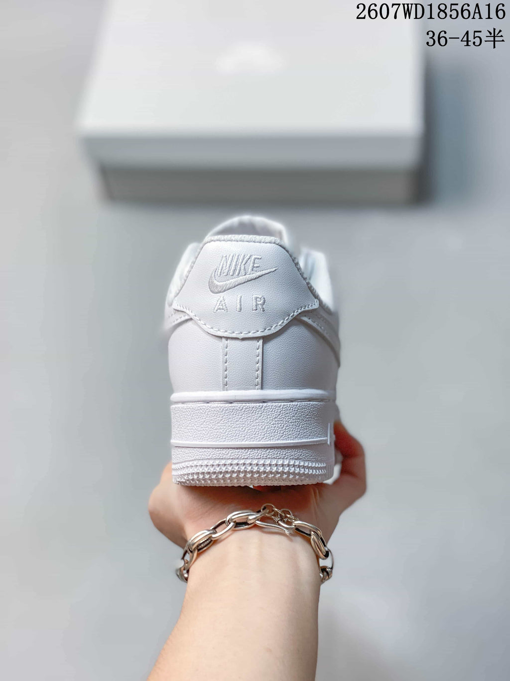 Rear view of the white low-top sneaker showing the heel tab with Nike and AIR branding and the raised outsole.