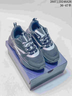Pair of dark gray and black Dior low-top sneakers with silver-gray accents displayed on a shoebox.