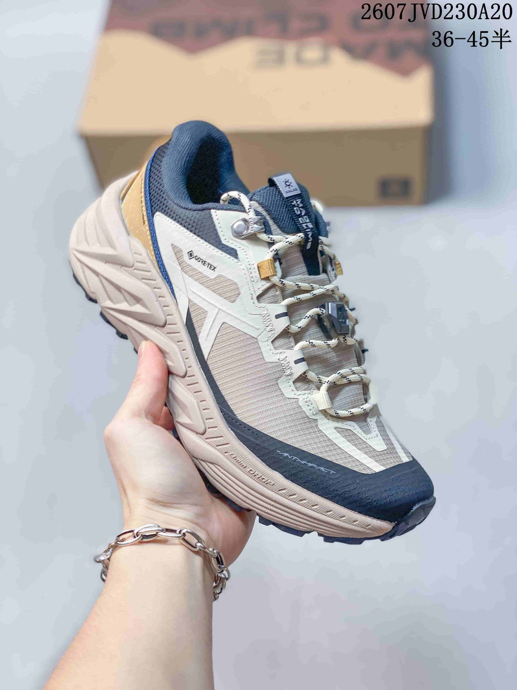 Angled side view showing the GORE-TEX side label, mesh-style upper panels, reinforced toe, and lugged outsole.