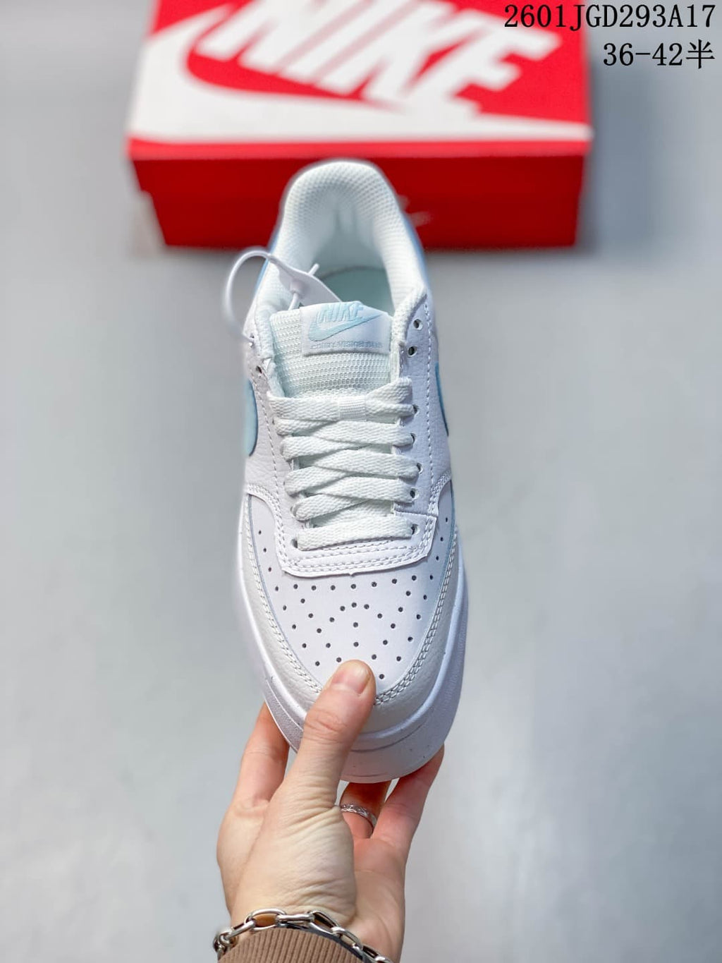 Top view of the white lace-up sneaker with a perforated toe panel.