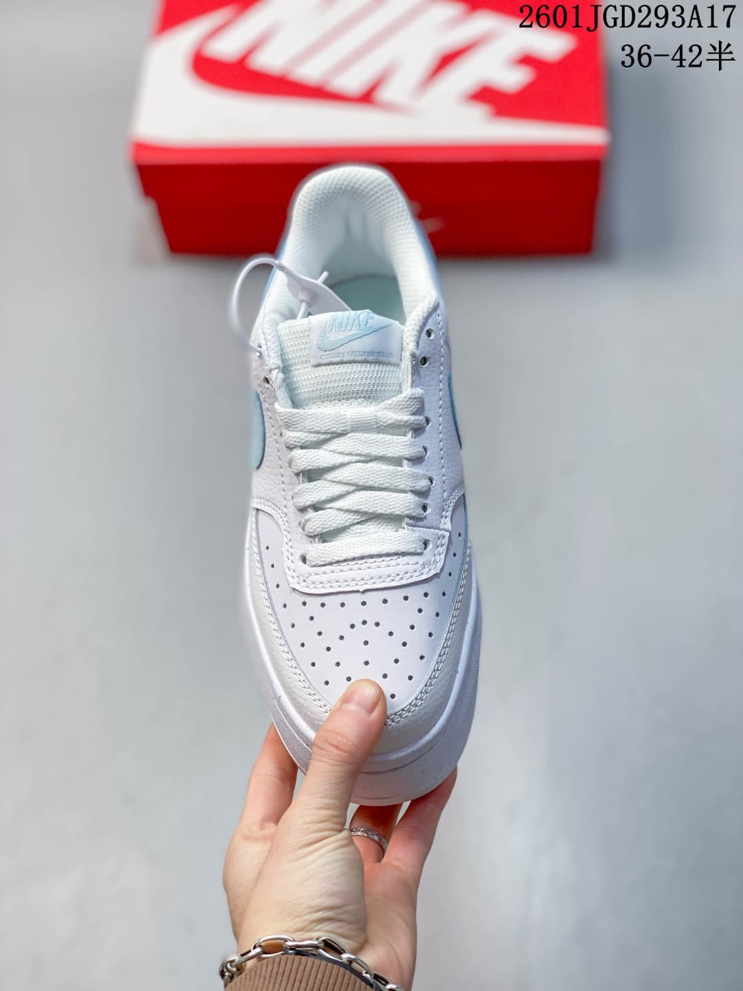 Top view of the white lace-up sneaker with a perforated toe panel.