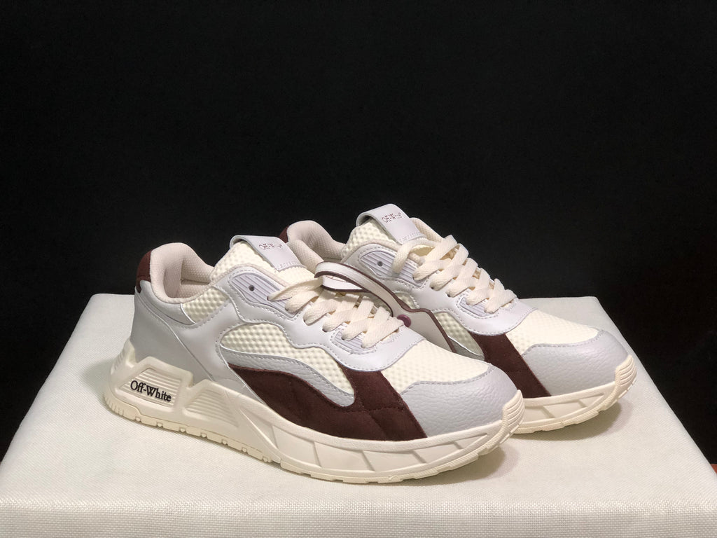 Three-quarter view of the white and brown sneaker pair with contrasting overlays and off-white soles.