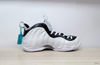 Side profile of a cream-white Nike Air Foamposite Pro shoe with black trim