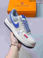 Angled side view of a blue and gray low-top sneaker with patterned panels and laces.