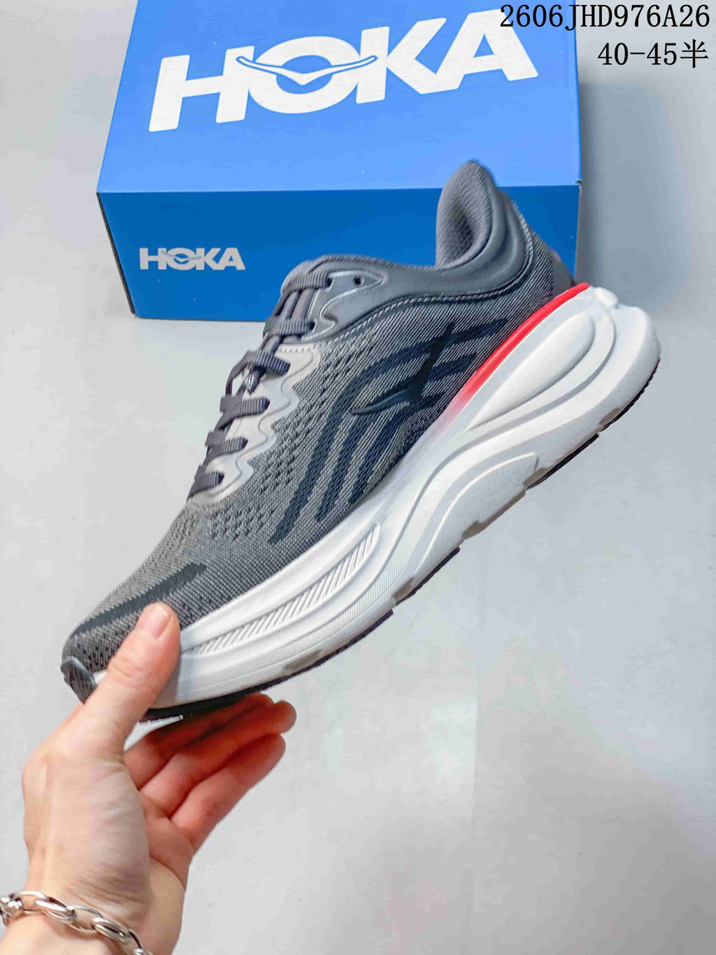 Side profile of a gray HOKA Bondi 9 running shoe with a white midsole