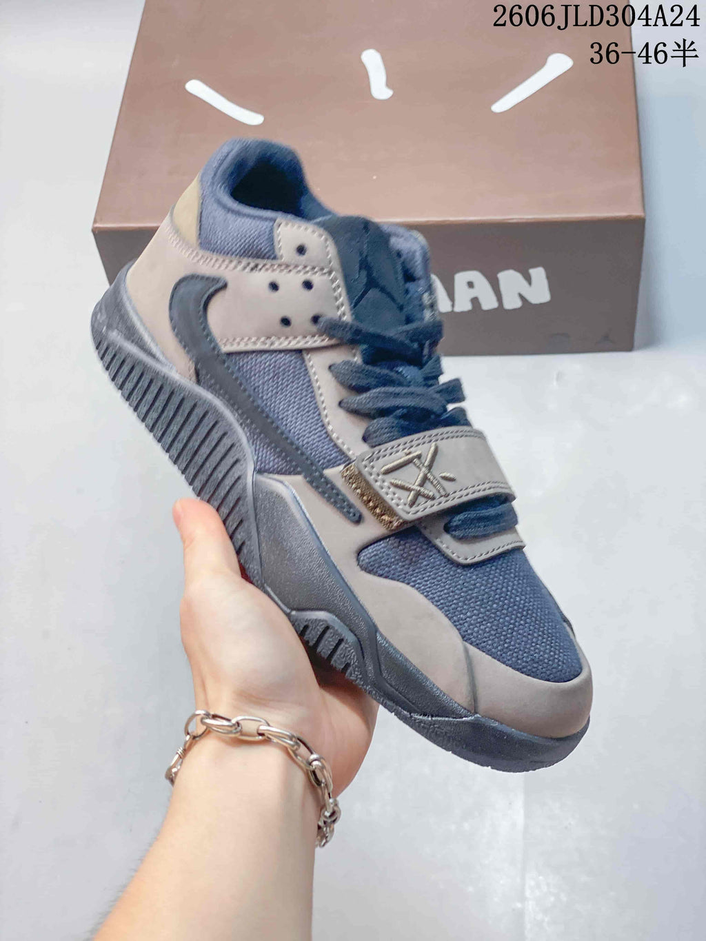Angled side view of the mocha and dark blue-gray Jordan Jumpman Jack sneaker