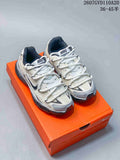 Pair of Nike Initiator sneakers in grey and white displayed on an orange shoebox; style code 2607GVD110A20 and size range 36–45.5 are visible at the top.
