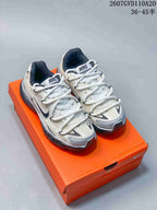 Pair of Nike Initiator sneakers in grey and white displayed on an orange shoebox; style code 2607GVD110A20 and size range 36–45.5 are visible at the top.