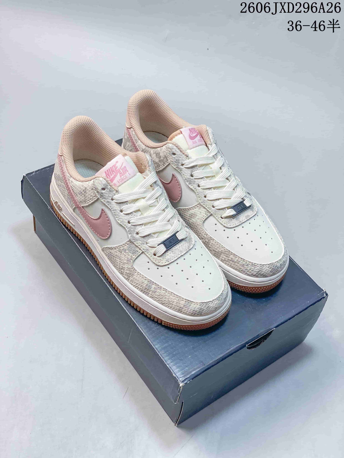 White Nike Air Force 1 sneakers with pink accents and patterned overlays.