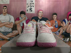 Front view of white Nike basketball sneakers with pink laces and textured pink outsoles