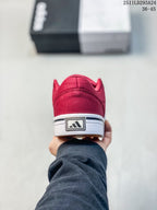 Rear view of the red sneaker showing the heel detail and white sole.