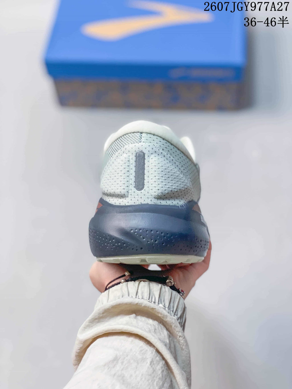 Rear view of the running shoe showing the padded heel collar and dark navy heel section.