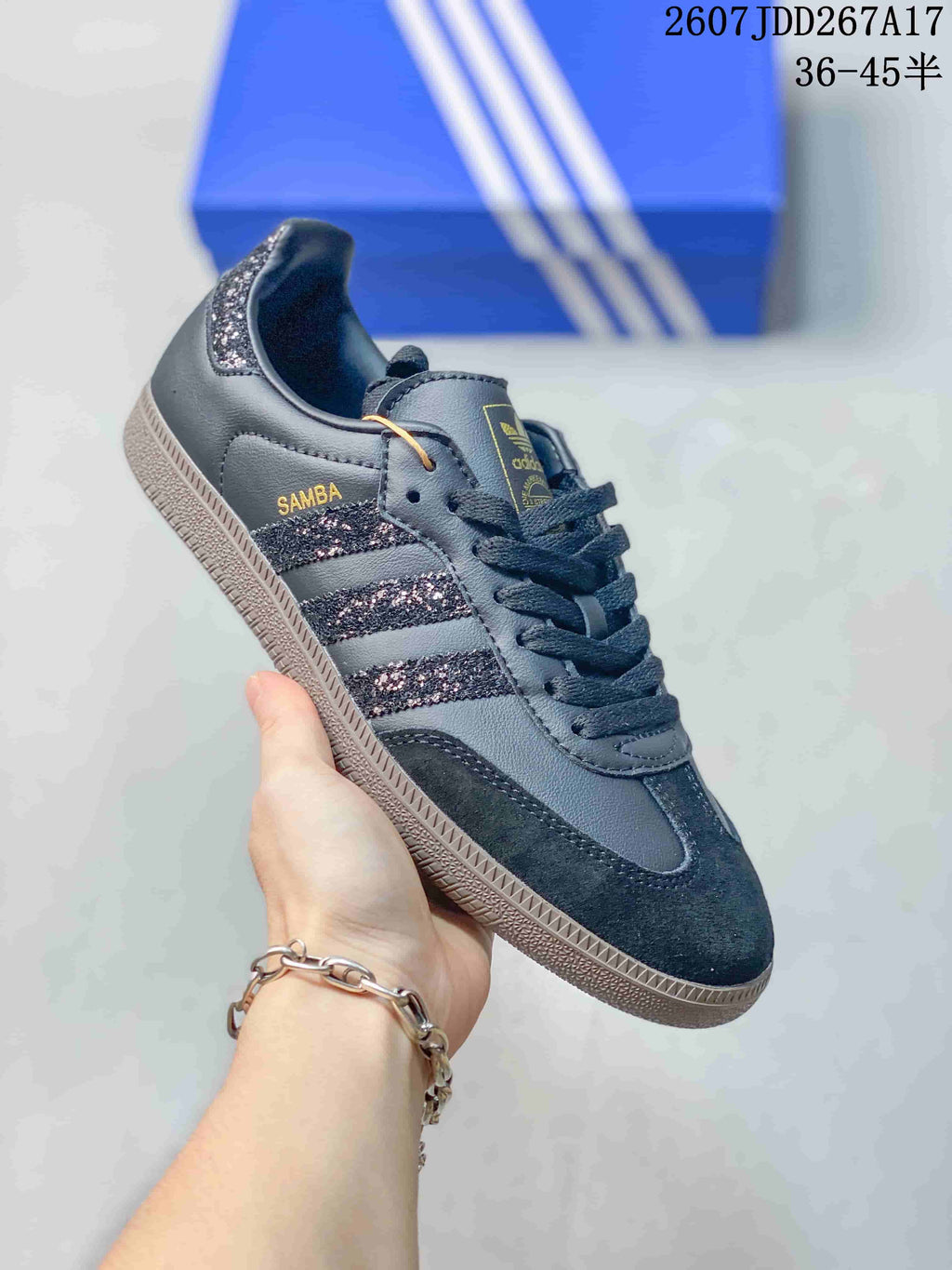 Side view of a black adidas Samba sneaker showing contrast stripes, textured panels, and a gum-colored outsole.
