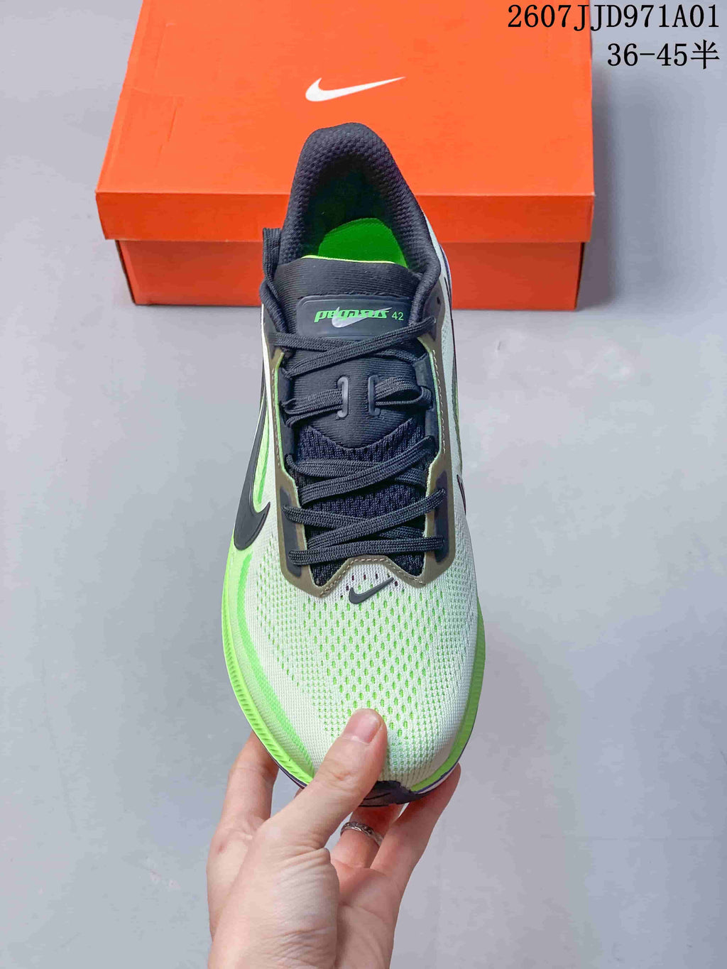 Top view of a Nike Pegasus 42 shoe with dark laces and a light grey, neon green upper
