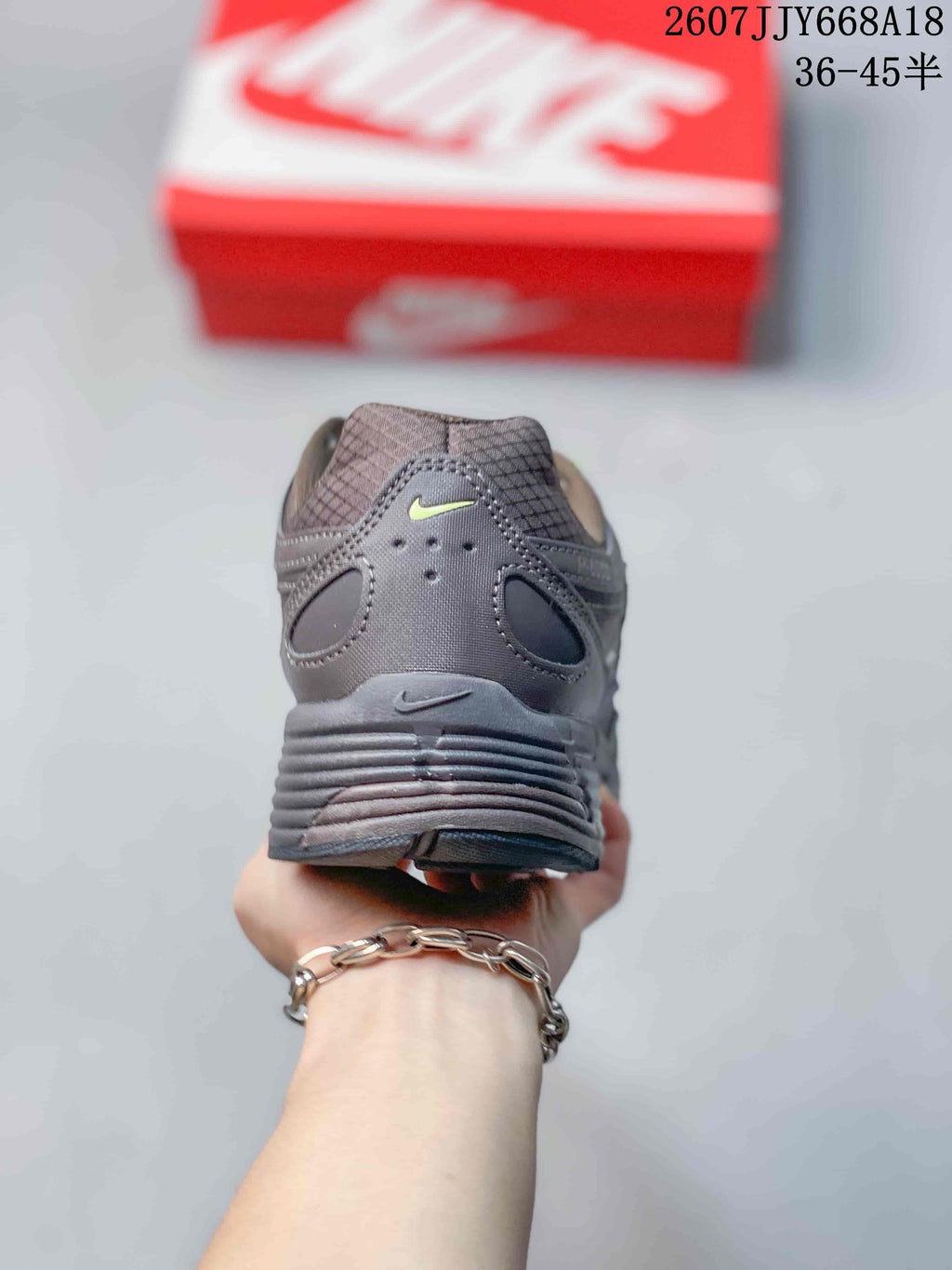 Rear view of a dark gray Nike P-6000 sneaker showing the padded heel and layered heel construction.