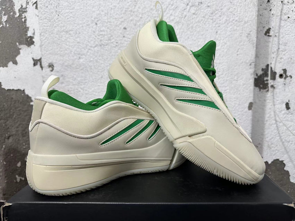 Cream and green Dame 9 shoes displayed together