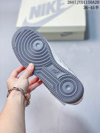 Close view of the gray rubber outsole with concentric circular traction patterns and textured edges.