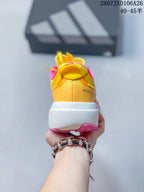 Rear view showing the yellow heel, pink collar and visible Adizero Evo SL branding.