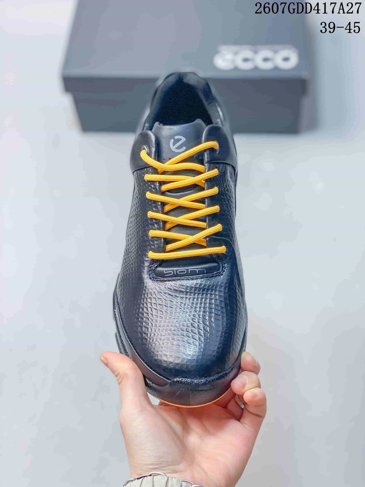 Top view of the black sneaker showing the yellow laces, textured toe, and BIOM tongue branding.