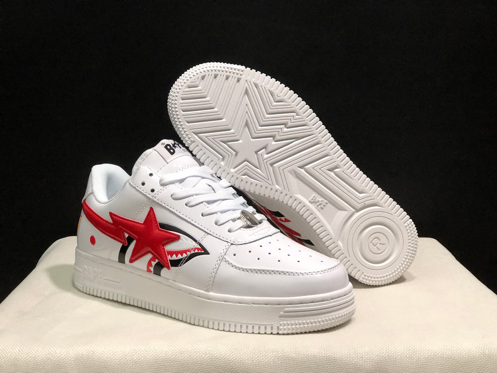 Angled view of the sneakers showing the red star side graphics and the patterned outsole with a large star motif.