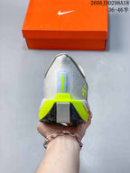 Rear view of the sneaker showing the padded heel, bright lime heel accent, and segmented black and pale blue outsole.