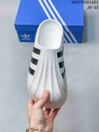 Top view of the white closed-toe mule slide with black side stripes
