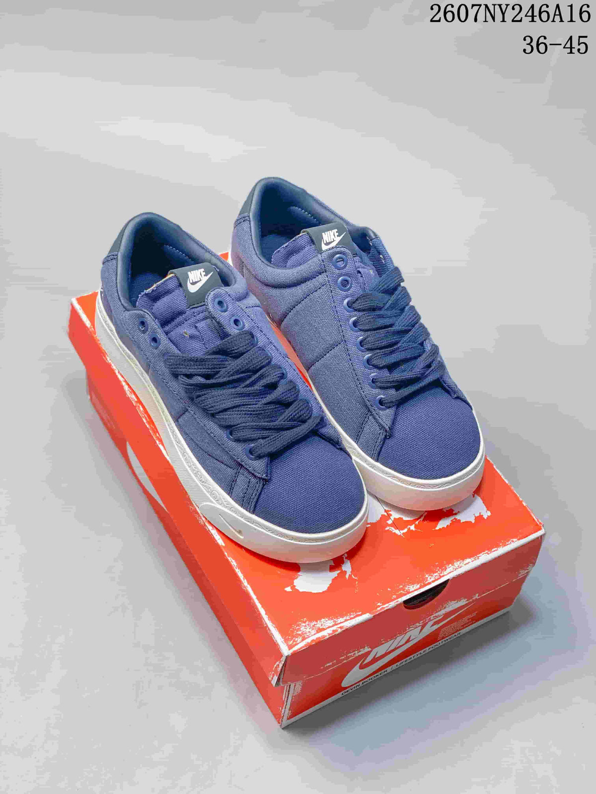 Pair of blue Nike Blazer Low sneakers displayed on a red Nike shoebox; image text shows style code 2607NY246A16 and size range 36–45.