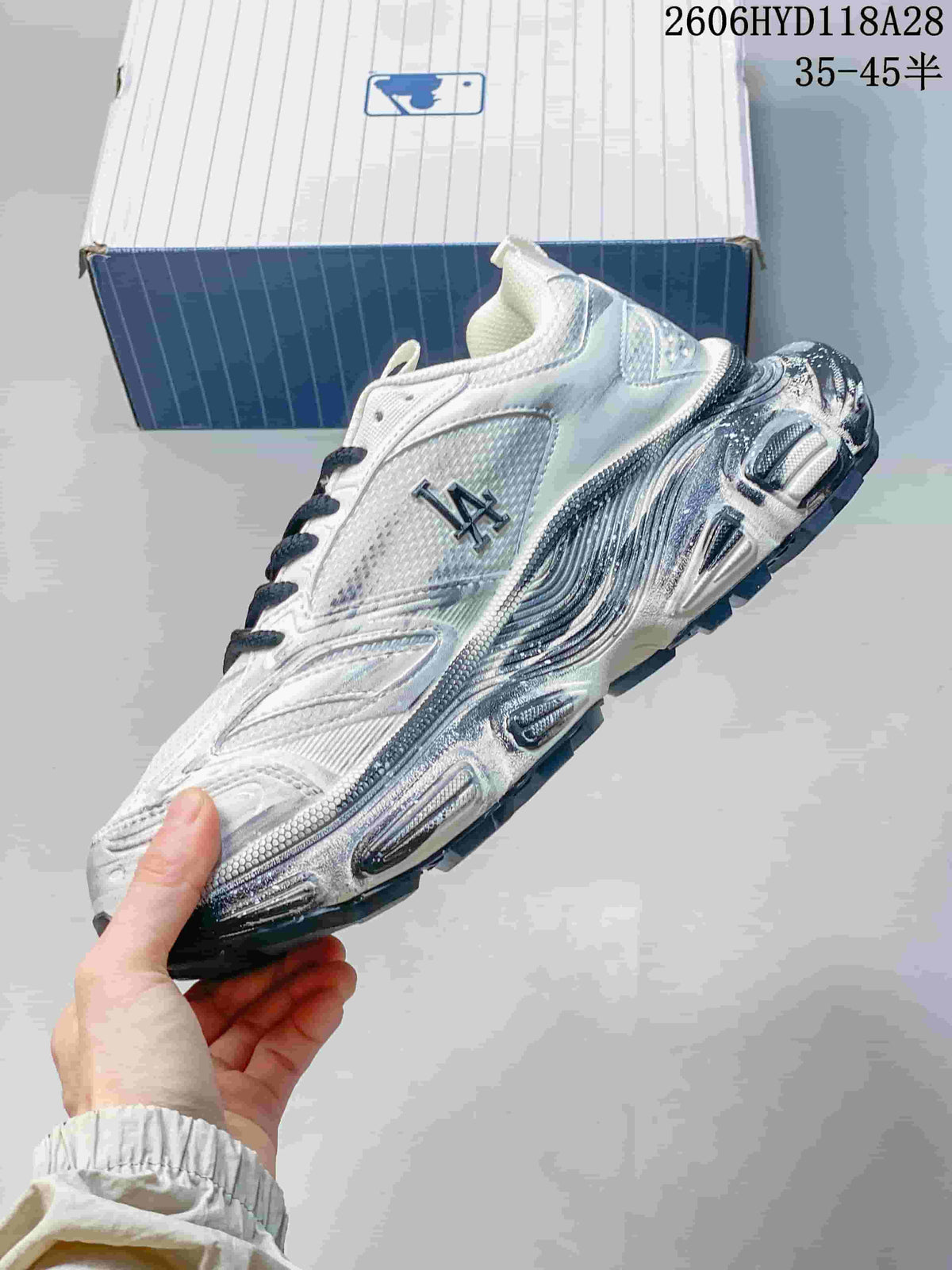 Side view showing the layered silver-toned panels and LA lettering