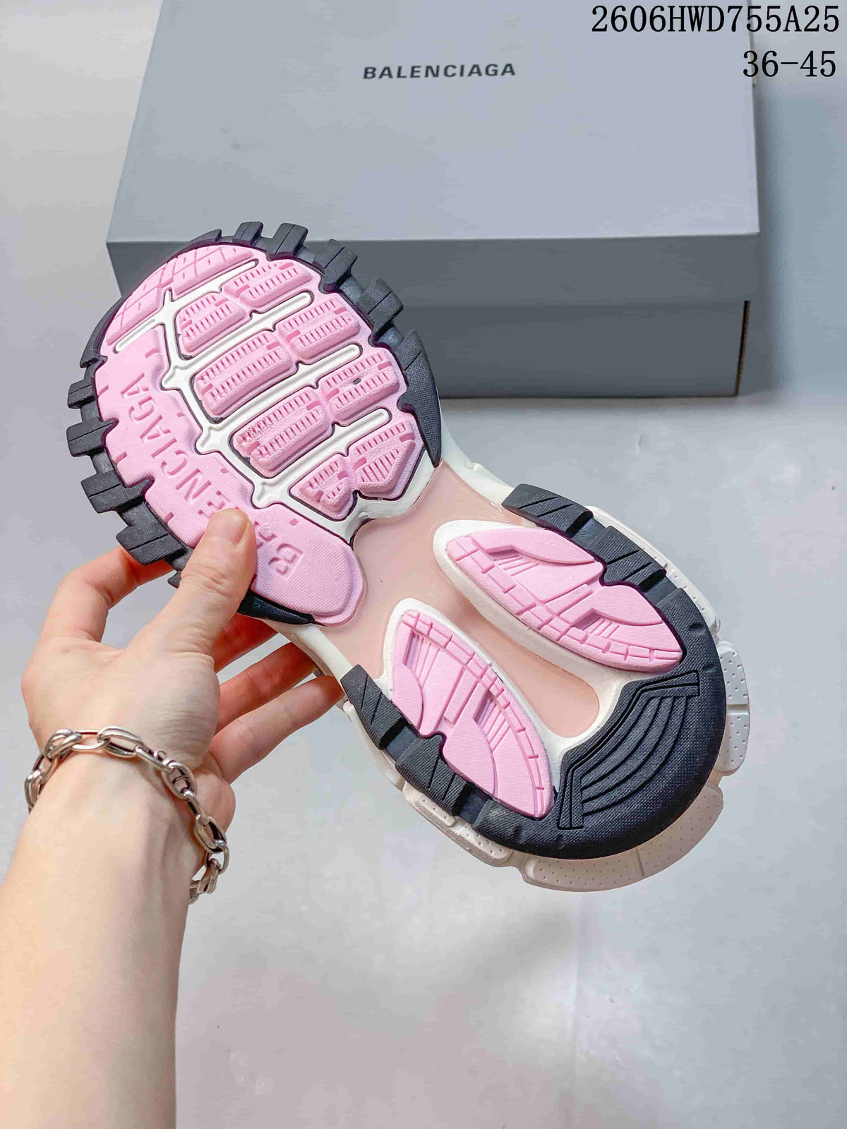 Underside of a Balenciaga Track 2 sneaker showing pink and dark outsole sections; an image overlay shows a 36–45 size range.