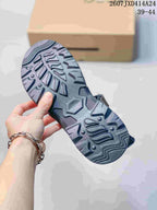 Close-up of the sandal outsole showing its dark, deeply textured tread pattern.
