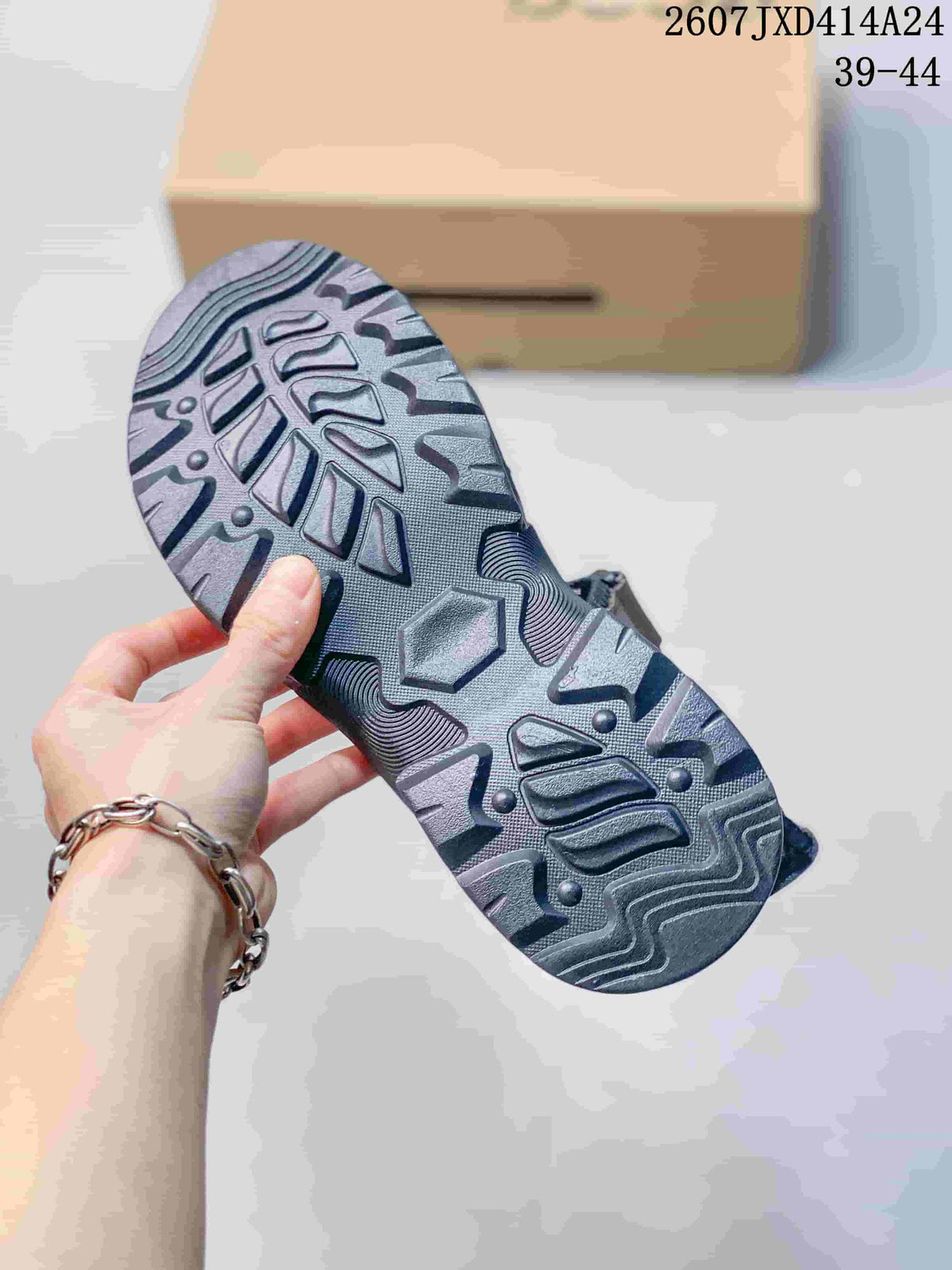 Close-up of the sandal outsole showing its dark, deeply textured tread pattern.