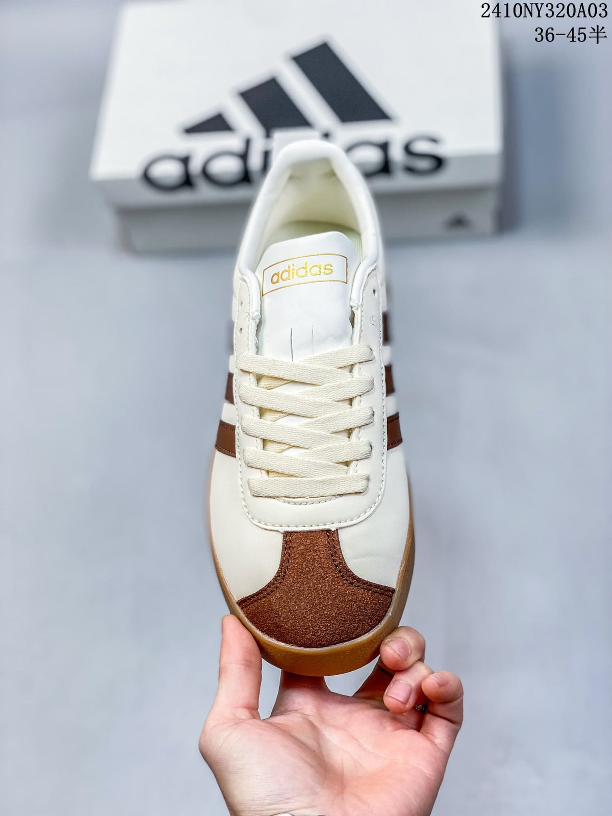 Top view showing the laces, tongue branding, white upper, and brown textured toe panel.
