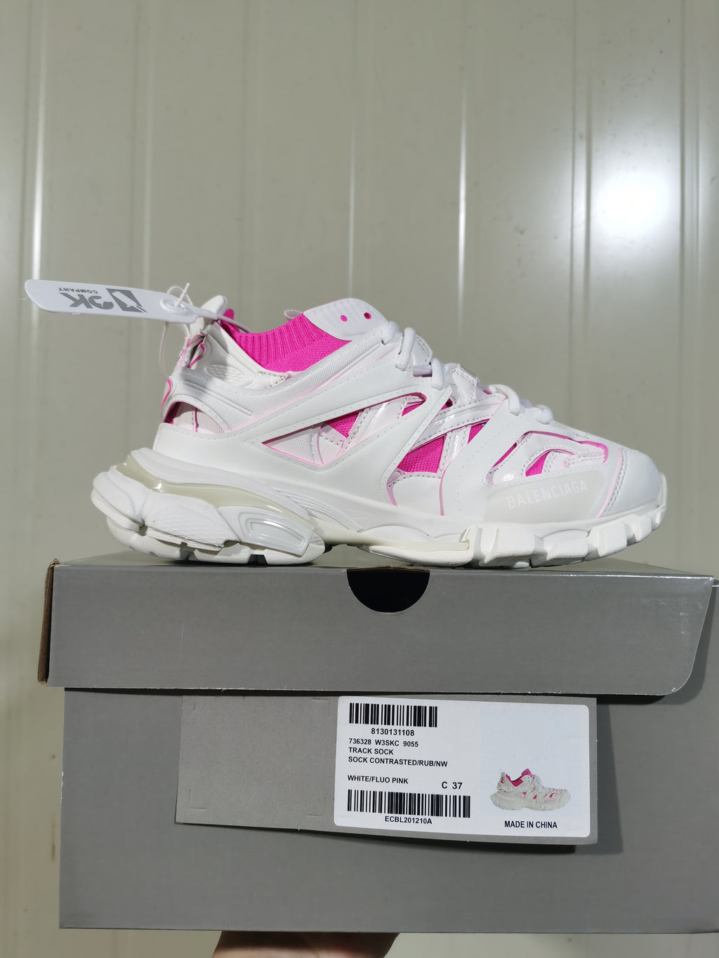 White and fluorescent pink Balenciaga Track Sock sneaker displayed on its box, with the box label showing style 9055 and size C 37.
