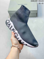 Angled side view of a dark gray Balenciaga sock-style sneaker with a ribbed ankle collar, white sculpted midsole, and black outsole.