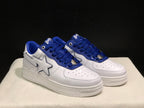 Three-quarter front view of the pair highlighting the white uppers, blue overlays, star-shaped side details, and perforated toe boxes.