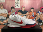 Side profile of a white Nike basketball shoe with red Swoosh and navy and red sole accents.