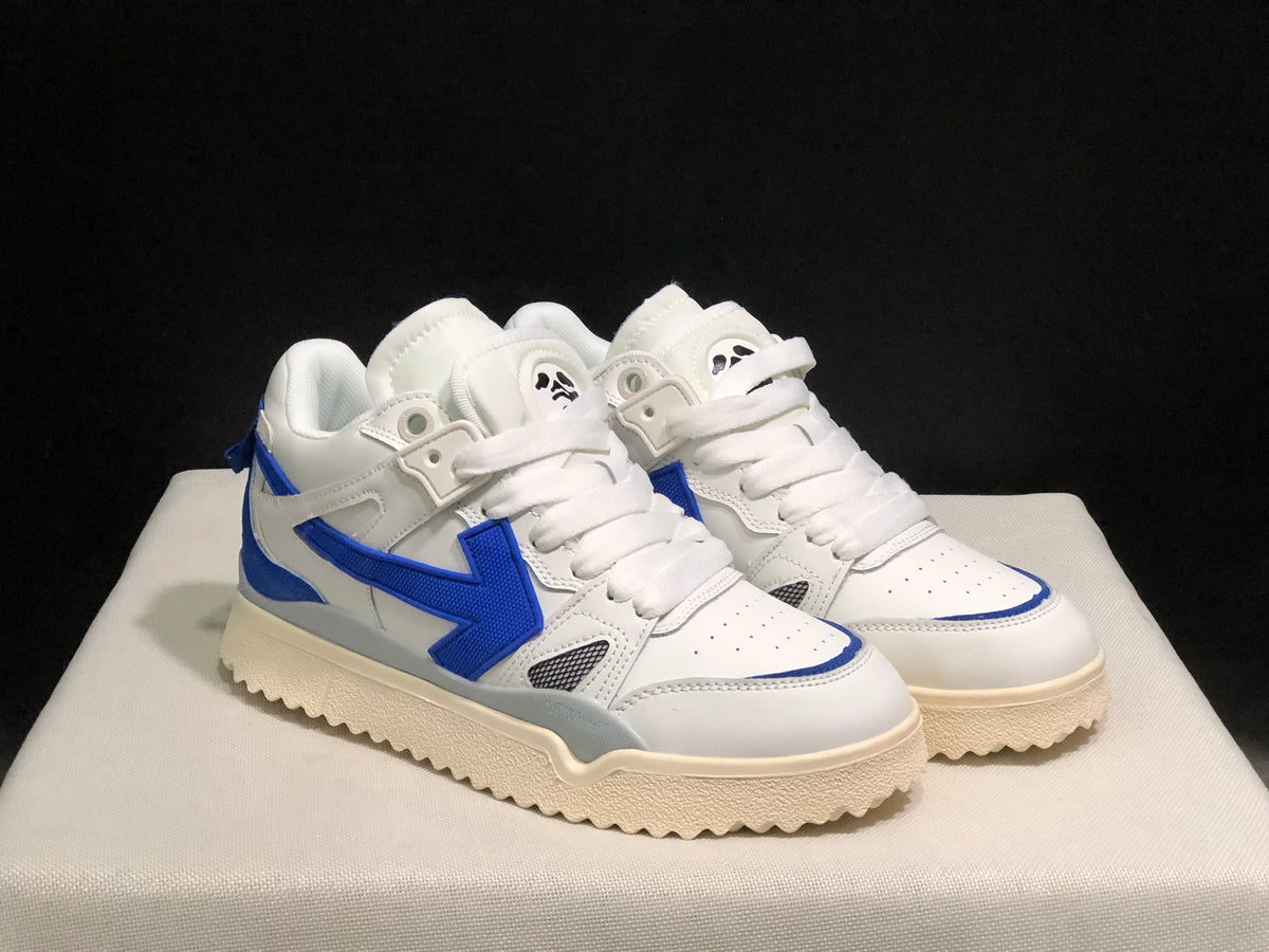Three-quarter front view of the pair highlighting the white uppers, royal blue accents, perforated toes, and layered construction.