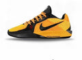 Yellow and black low-cut Nike basketball shoe with a black Swoosh and contrasting laces